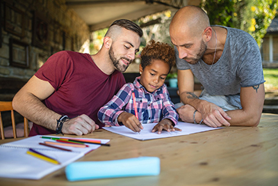 same sex parents helping their child with school work